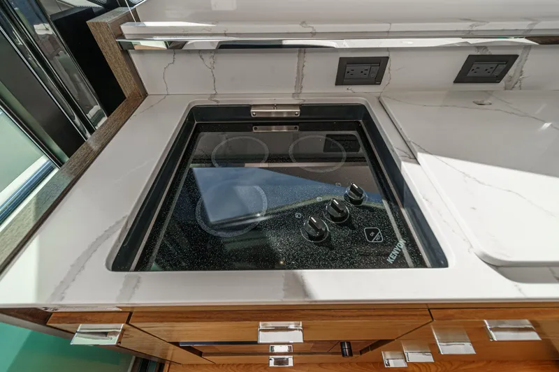 Slide: The Image of Modern kitchen stove in 2021 Tiara Yachts 53 Coupe with sleek countertop design. - 43