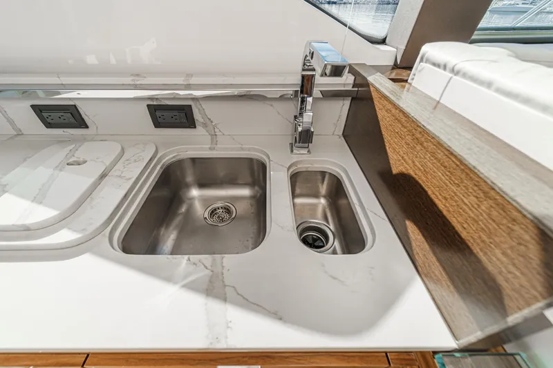 Slide: The Image of Modern kitchen sink area in 2021 Tiara Yachts 53 Coupe with marble countertop. - 44