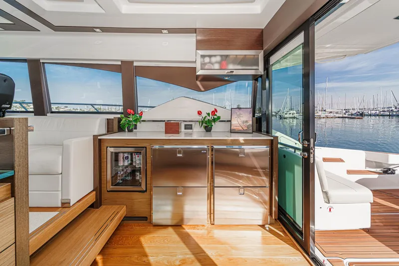 Slide: The Image of Interior of 2021 Tiara Yachts 53 Coupe with modern design and marina view. - 45