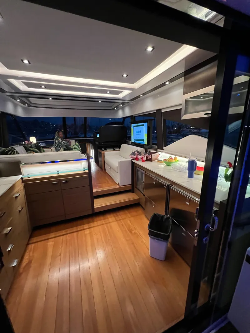 Slide: The Image of Luxurious interior of 2021 Tiara Yachts 53 Coupe with modern kitchen and seating area. - 6