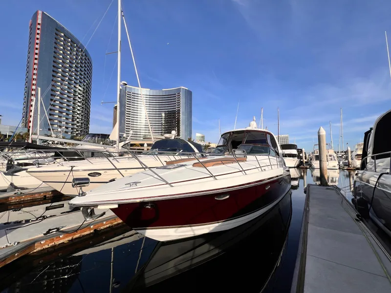 The Image of 2008 Formula 37 PC yacht docked in marina with modern buildings in background. - 0
