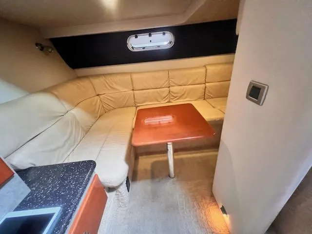 Slide: The Image of Interior of 2008 Formula 37 PC yacht with beige seating and wooden table. - 11