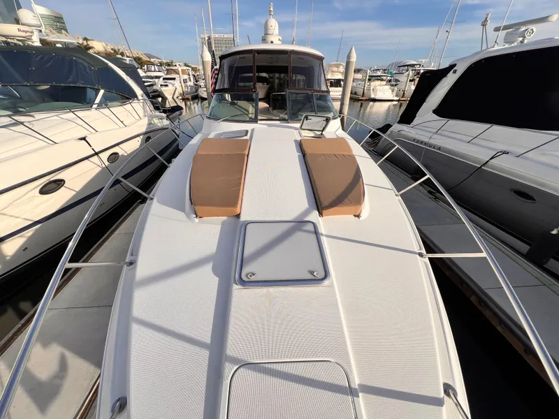 Slide: The Image of 2008 Formula 37 PC yacht docked at marina, featuring spacious deck and sunbathing area. - 15