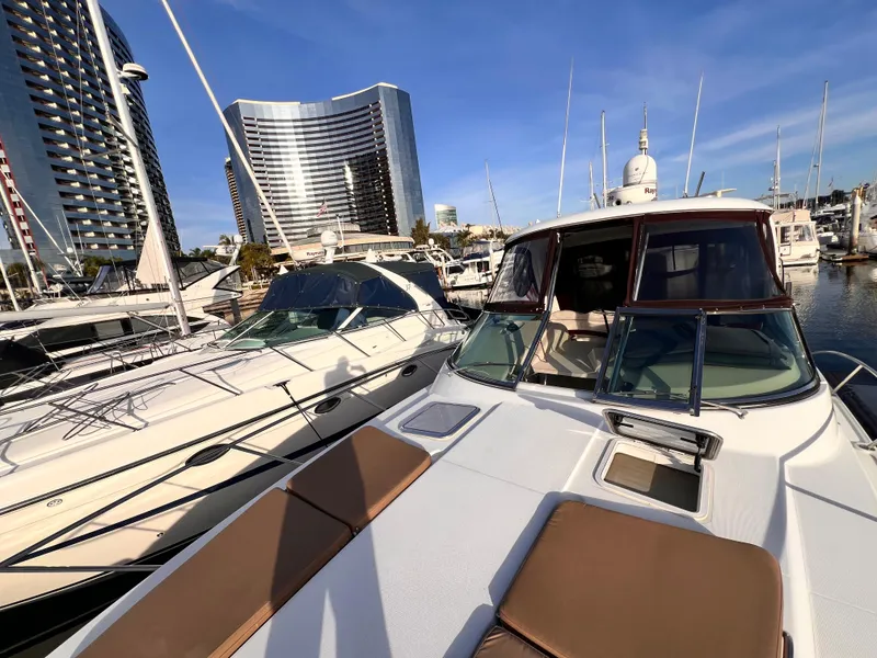 Slide: The Image of 2008 Formula 37 PC yacht docked in marina with modern buildings in background. - 16