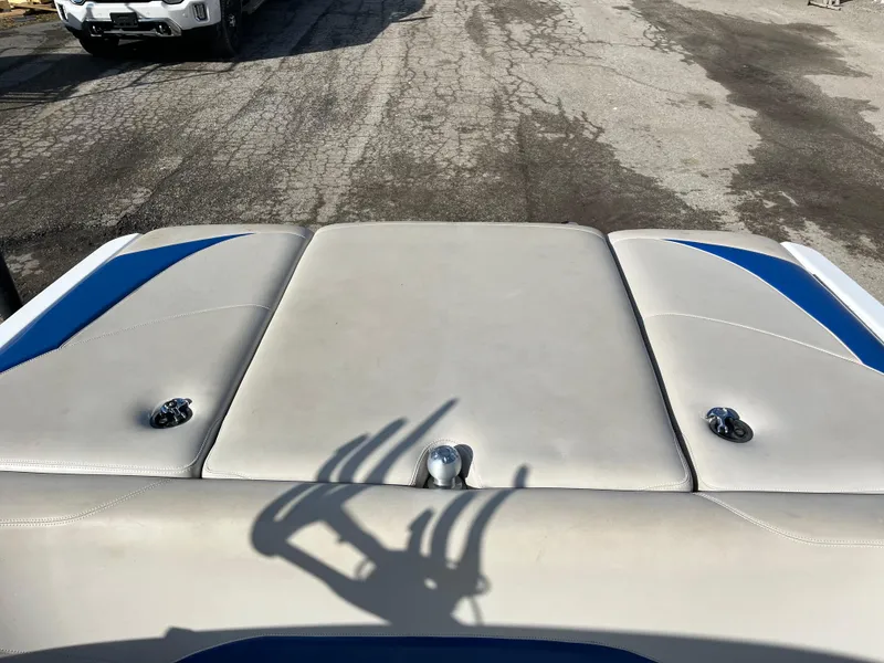 Slide: The Image of 2010 Malibu 21 vRide boat interior with blue accents and shadow on upholstery. - 10