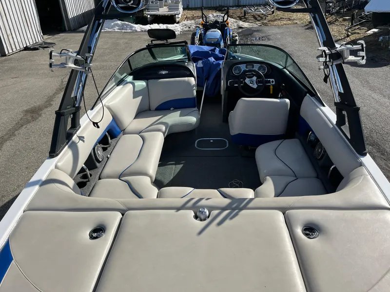 Slide: The Image of 2010 Malibu 21 vRide boat interior with spacious seating and modern design. - 11
