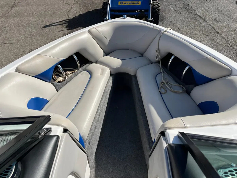 Slide: The Image of 2010 Malibu 21 vRide boat interior with cushioned seating and rope. - 13