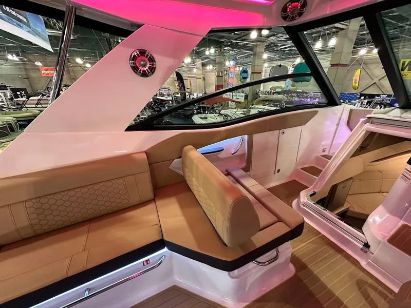 Slide: The Image of 2025 Sea Ray Sundancer 320 interior with tan seating and modern design. - 11