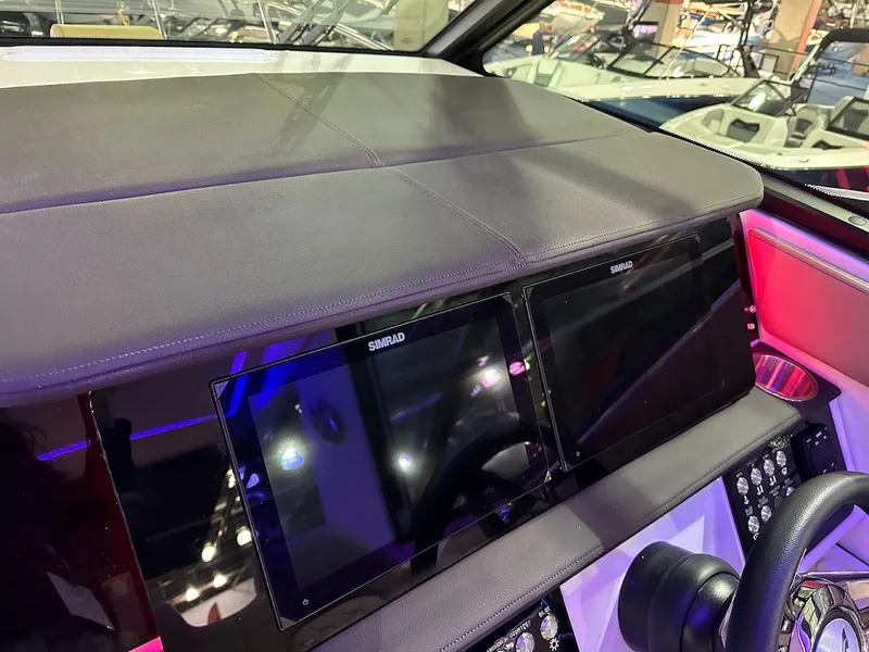 Slide: The Image of 2025 Sea Ray Sundancer 320 helm with dual Simrad displays and modern controls. - 15