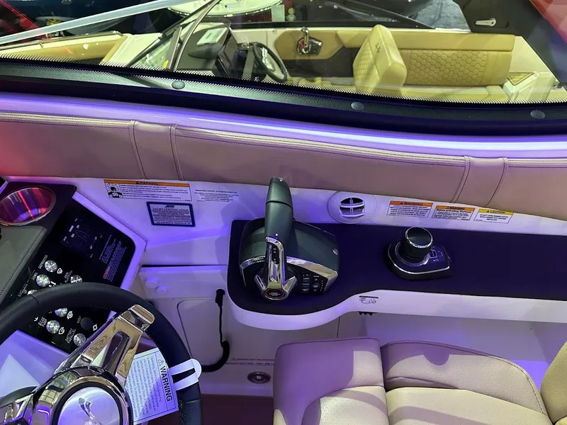 Slide: The Image of 2025 Sea Ray Sundancer 320 helm with modern controls and luxurious seating. - 16