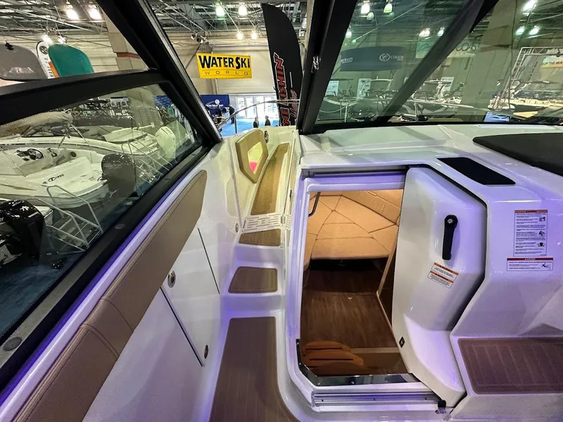 Slide: The Image of 2025 Sea Ray Sundancer 320 interior view at a boat show, showcasing modern design. - 17