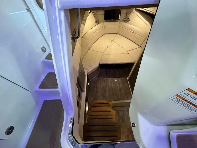 Slide: The Image of 2025 Sea Ray Sundancer 320 cabin interior with cozy seating and modern design. - 18