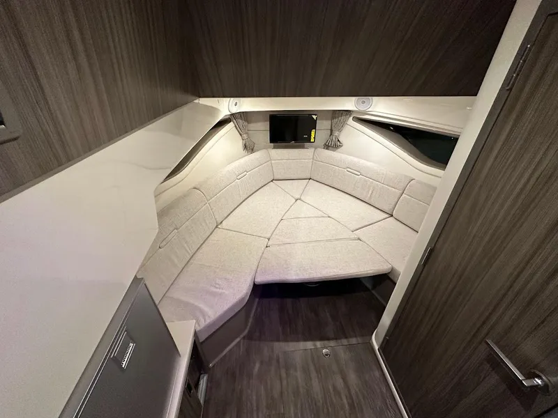 Slide: The Image of 2025 Sea Ray Sundancer 320 cabin interior with modern design and comfortable seating. - 19