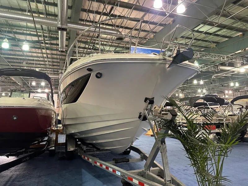 Slide: The Image of 2025 Sea Ray Sundancer 320 boat displayed indoors on a trailer. - 2
