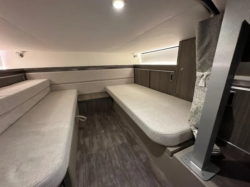 Slide: The Image of Interior cabin of 2025 Sea Ray Sundancer 320 with modern seating and lighting. - 25