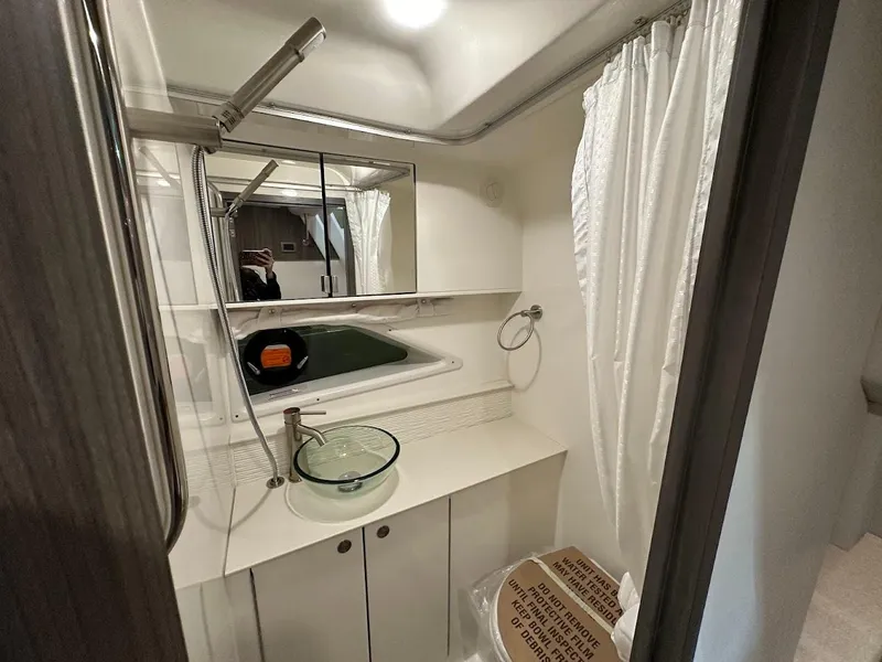Slide: The Image of Bathroom interior of 2025 Sea Ray Sundancer 320 yacht, featuring modern fixtures and design. - 27
