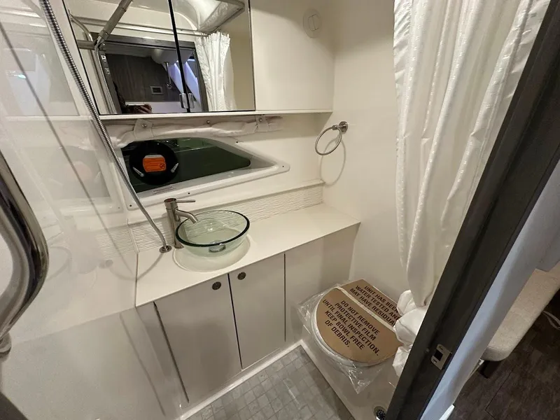 Slide: The Image of 2025 Sea Ray Sundancer 320 bathroom with modern fixtures and compact design. - 28