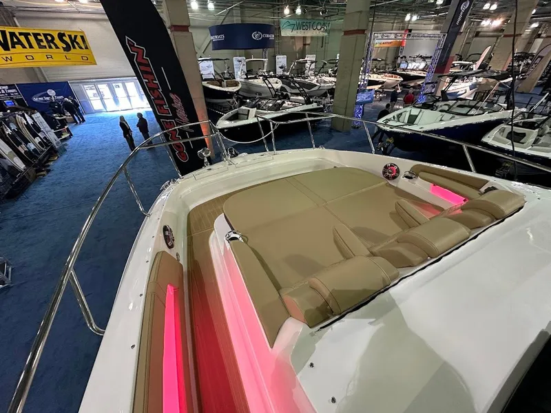 Slide: The Image of 2025 Sea Ray Sundancer 320 at a boat show, featuring spacious deck and modern design. - 30