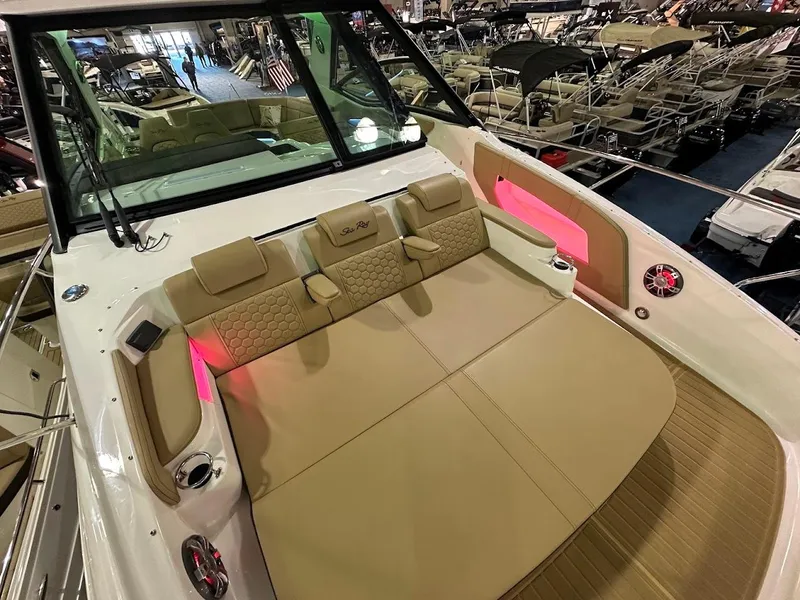 Slide: The Image of 2025 Sea Ray Sundancer 320 interior with luxurious seating and ambient lighting. - 32