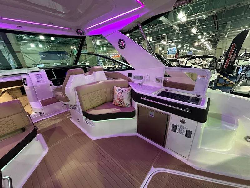 Slide: The Image of Interior of 2025 Sea Ray Sundancer 320 yacht with modern seating and ambient lighting. - 9