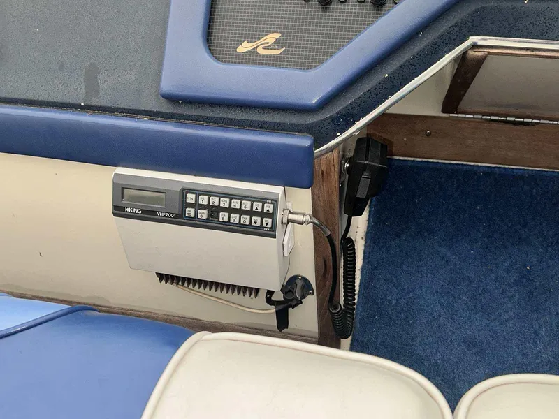 Slide: The Image of 1987 Sea Ray 270 Sundancer boat interior with radio and blue upholstery. - 10