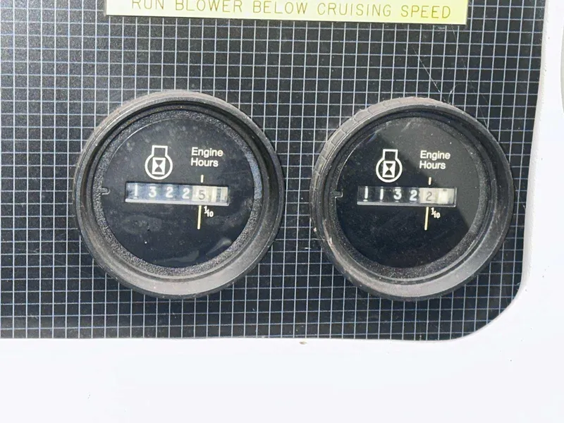 Slide: The Image of 1987 Sea Ray 270 Sundancer engine hour meters displaying 1322.5 and 1322.1 hours. - 12