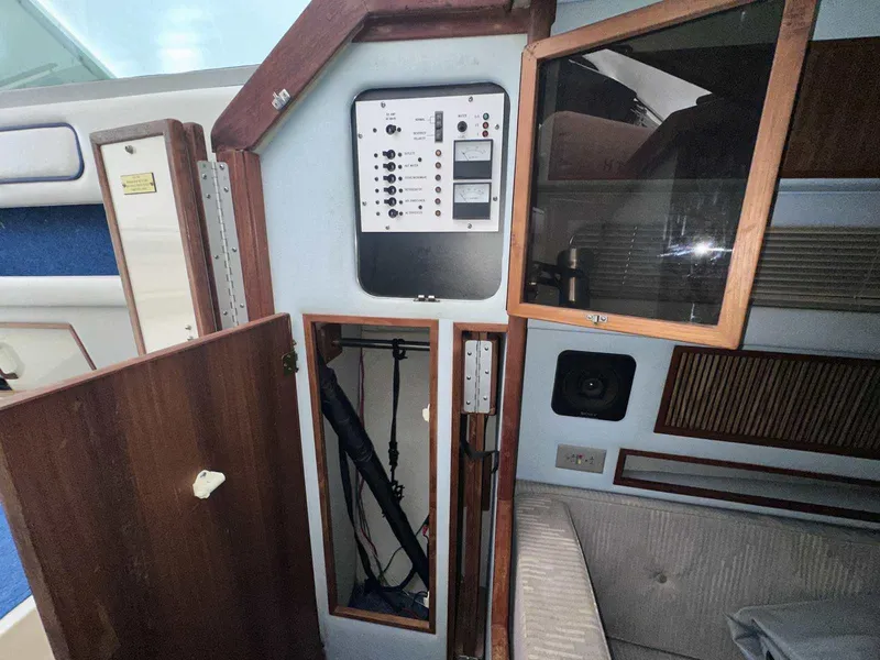 Slide: The Image of 1987 Sea Ray 270 Sundancer cabin interior with control panel and storage compartments. - 17