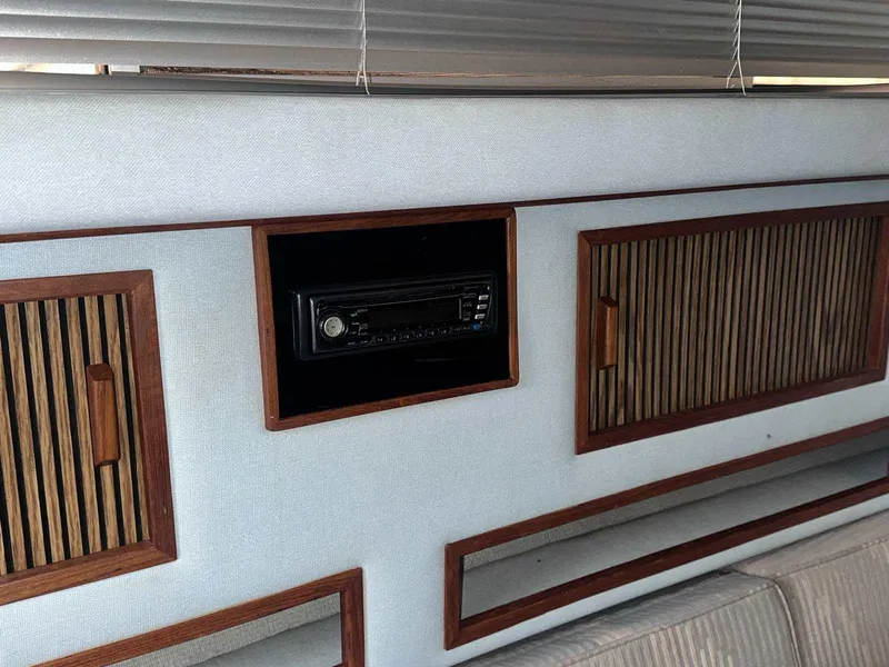 Slide: The Image of 1987 Sea Ray 270 Sundancer interior with wood paneling and built-in stereo system. - 18
