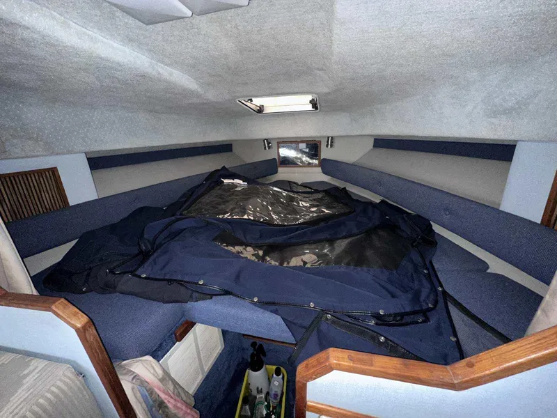 Slide: The Image of Interior cabin of 1987 Sea Ray 270 Sundancer with blue upholstery and storage space. - 20