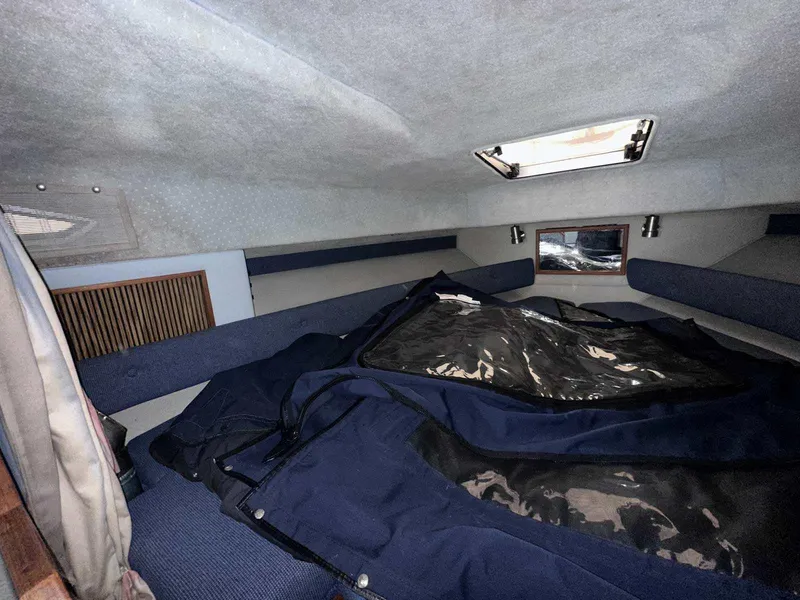 Slide: The Image of Interior cabin of 1987 Sea Ray 270 Sundancer with blue upholstery and overhead hatch. - 21