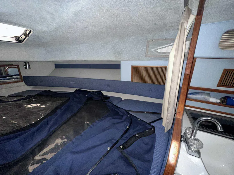 Slide: The Image of Interior cabin of 1987 Sea Ray 270 Sundancer with blue upholstery and compact sink. - 22