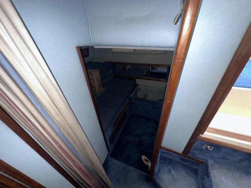 Slide: The Image of Interior cabin of 1987 Sea Ray 270 Sundancer with blue carpet and wood accents. - 23
