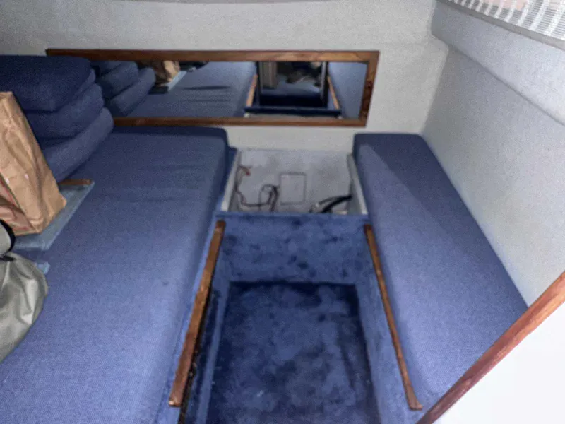 Slide: The Image of 1987 Sea Ray 270 Sundancer cabin interior with blue seating and carpet. - 24