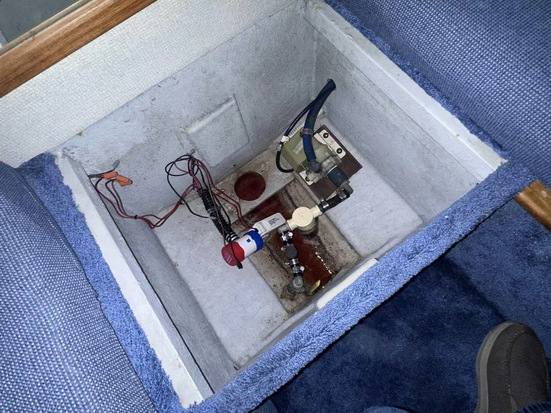 Slide: The Image of Bilge compartment of 1987 Sea Ray 270 Sundancer with wiring and pump components. - 25