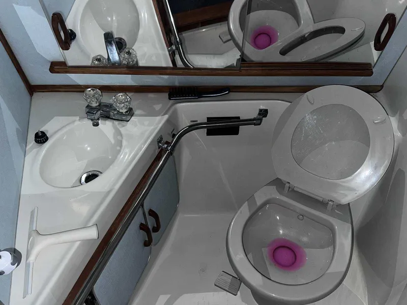 Slide: The Image of 1987 Sea Ray 270 Sundancer bathroom with sink, mirror, and toilet. - 30