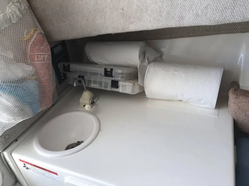 Slide: The Image of 2008 Seaswirl 2601 Walkaround I/O cabin sink with storage and paper towels. - 13
