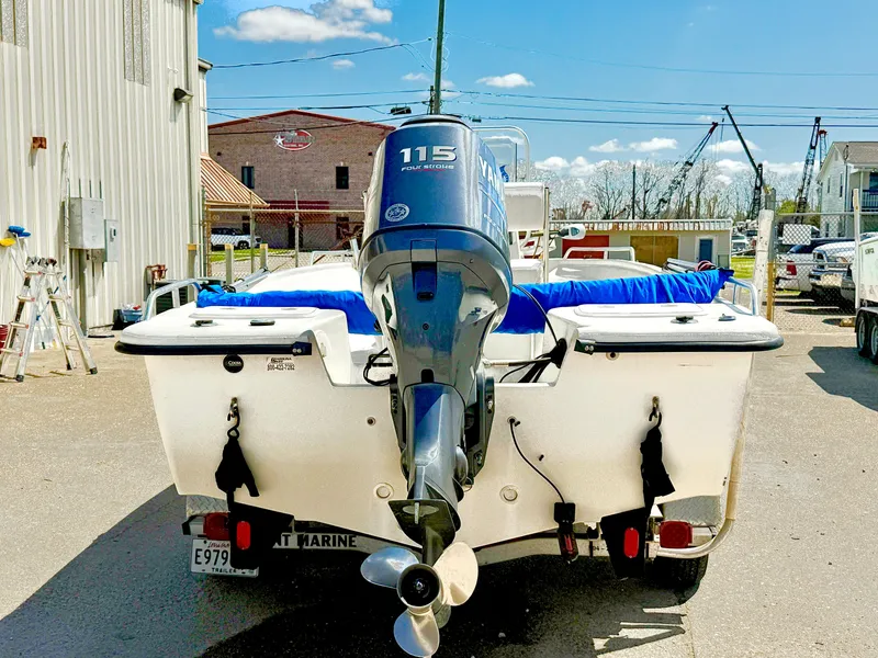 Slide: The Image of 2005 Sea Chaser 1950 RG boat with 115 horsepower outboard motor, parked outdoors. - 12