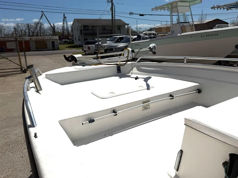 Slide: The Image of 2005 Sea Chaser 1950 RG boat docked, showcasing spacious deck and storage compartments. - 4