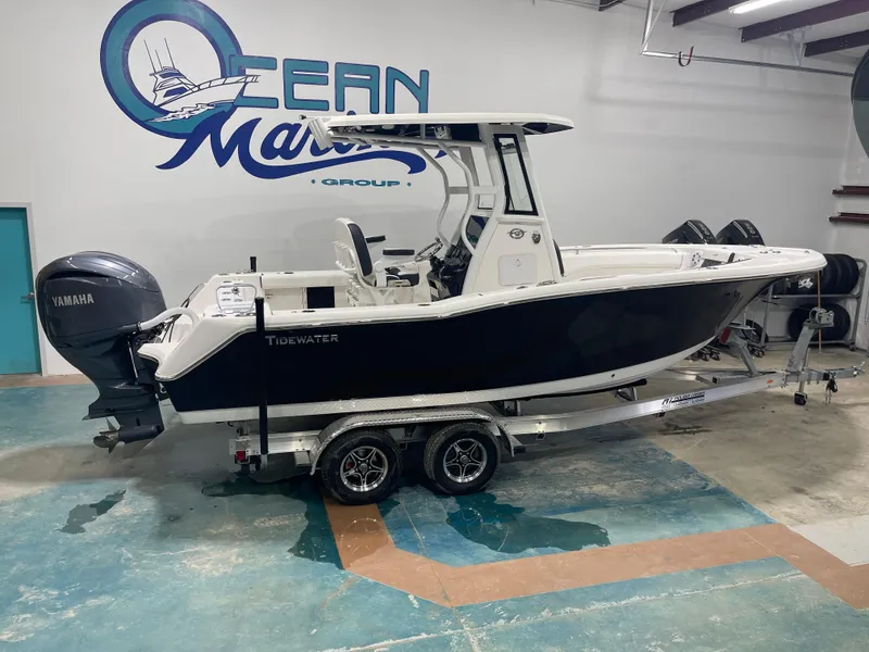 Slide: The Image of 2023 Tidewater 232cc boat on trailer in showroom with Yamaha engine. - 1