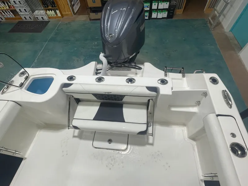 Slide: The Image of 2023 Tidewater 232cc boat interior with Yamaha engine, featuring seating and storage compartments. - 11