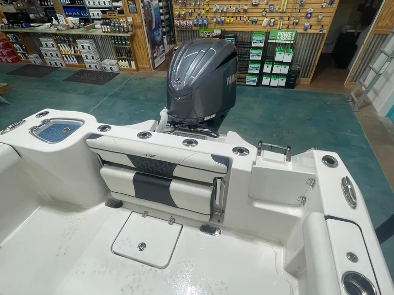 Slide: The Image of 2023 Tidewater 232cc boat interior with Yamaha engine in showroom. - 12