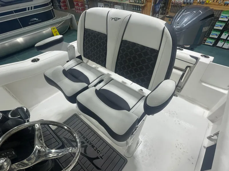 Slide: The Image of 2023 Tidewater 232cc boat interior with dual seats and steering wheel. - 13
