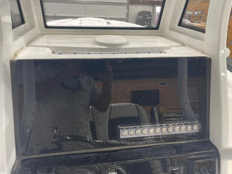Slide: The Image of 2023 Tidewater 232cc boat dashboard with control panel and windshield. - 17