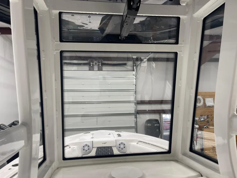Slide: The Image of Interior view of 2023 Tidewater 232cc boat cabin with windows and storage area. - 18