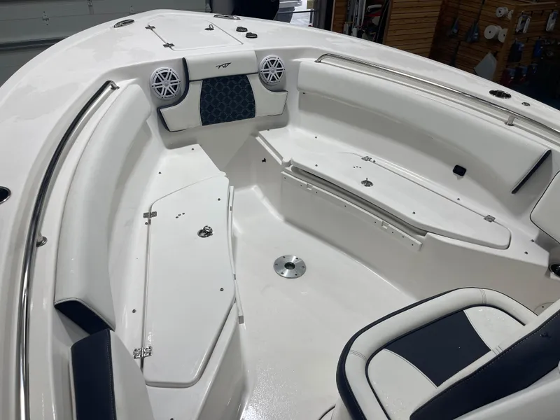 Slide: The Image of 2023 Tidewater 232cc boat interior with white seating and storage compartments. - 19