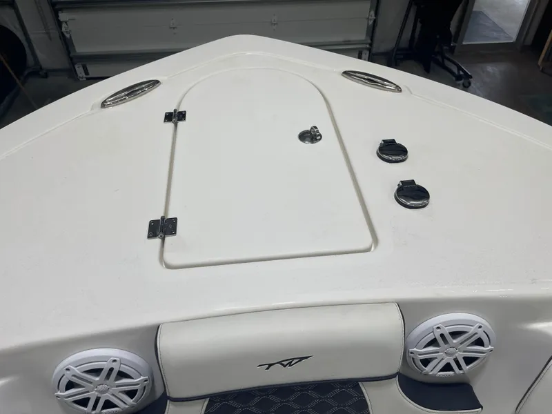 Slide: The Image of 2023 Tidewater 232cc boat deck with storage hatch and speakers. - 20