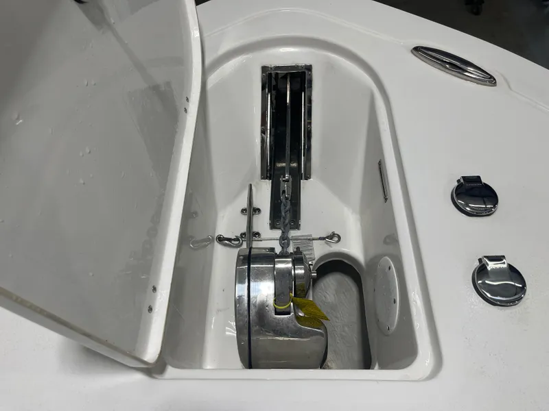 Slide: The Image of Anchor compartment of 2023 Tidewater 232cc boat with open hatch and metal fittings. - 21