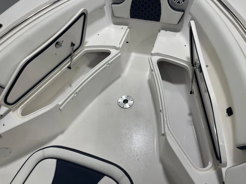 Slide: The Image of 2023 Tidewater 232cc boat interior with open storage compartments and seating. - 22