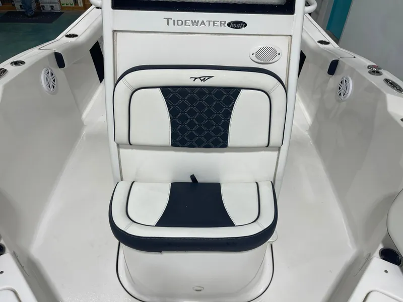 Slide: The Image of 2023 Tidewater 232cc boat interior with cushioned seating and speaker system. - 23