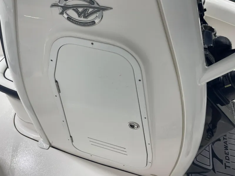 Slide: The Image of 2023 Tidewater 232cc boat console with storage compartment and Adventure logo. - 25